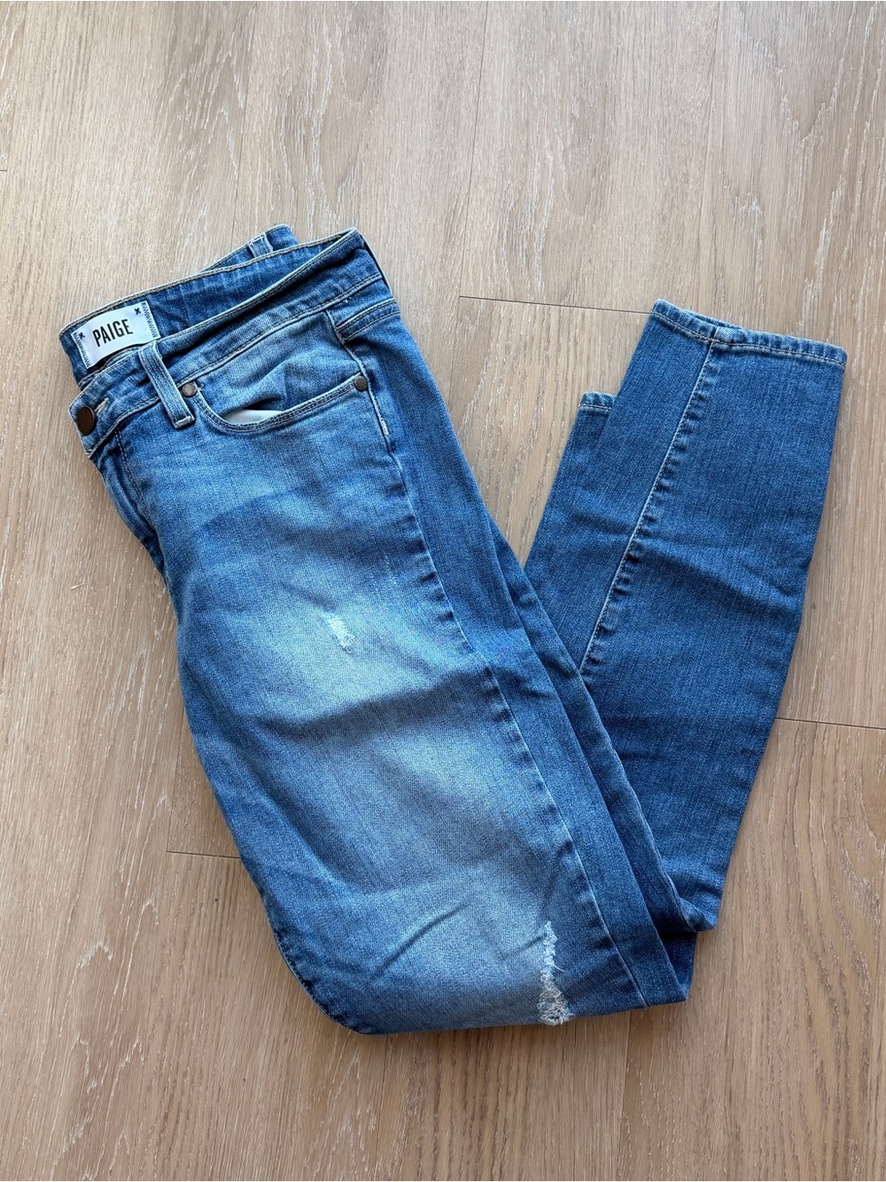 Paige medium wash lightly distressed skinny ankle jeans